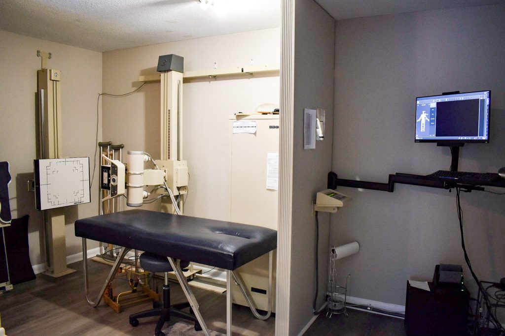 Interior of a chiropractor’s office with treatment tables and equipment, showing a welcoming environment for patients using insurance for chiropractor visits.